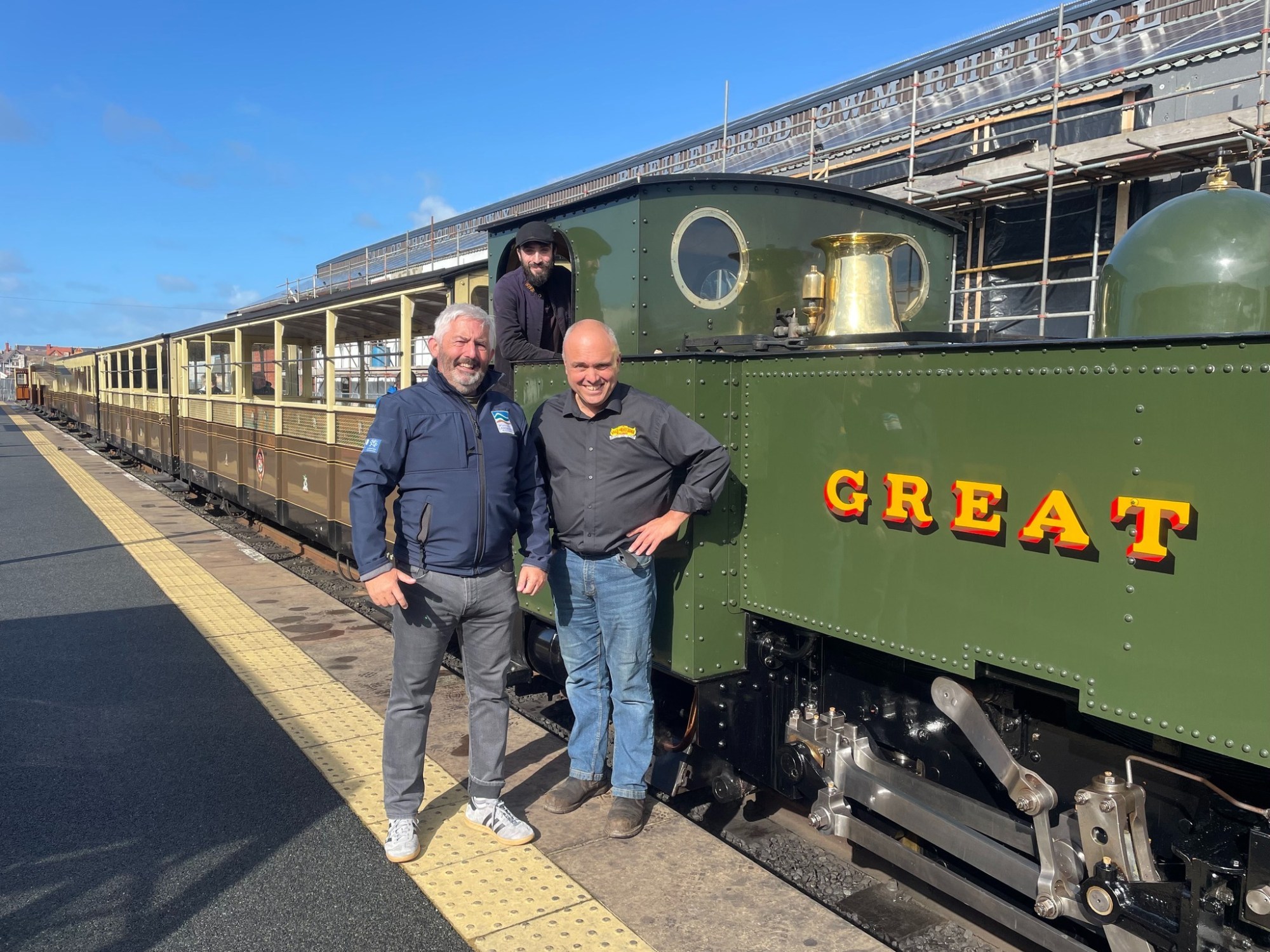 a man standing next to a train