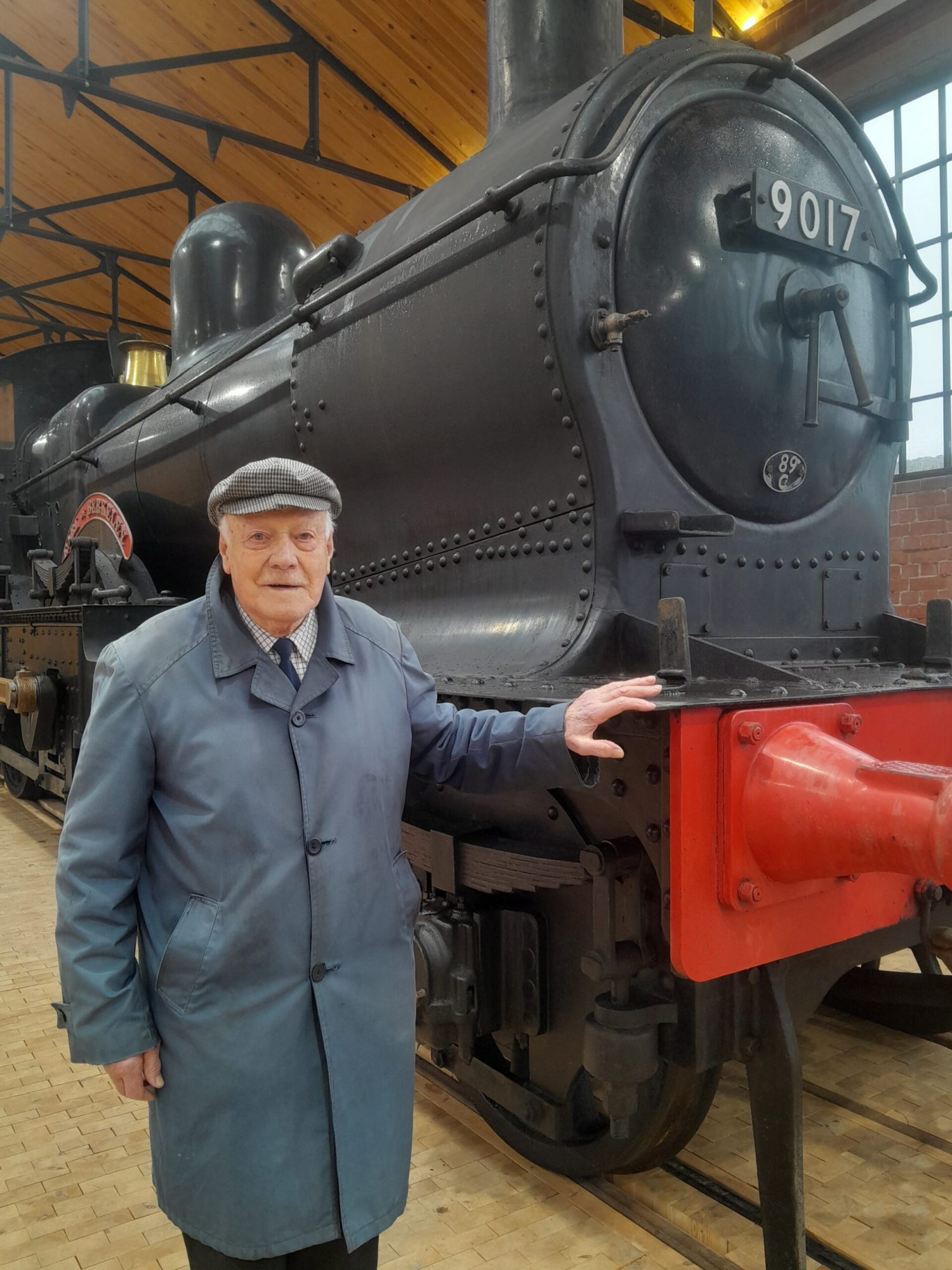 20240228_144546 a man standing next to a train