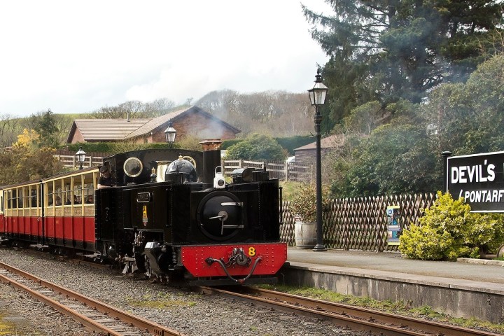 a train engine carrying carts down a track
