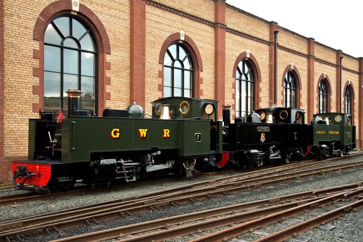 a train is parked on the side of a building