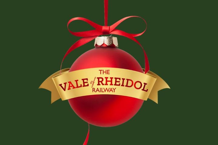 Red Christmas bauble with 'The Vale of Rheidol Railway' text on a gold ribbon, green background.