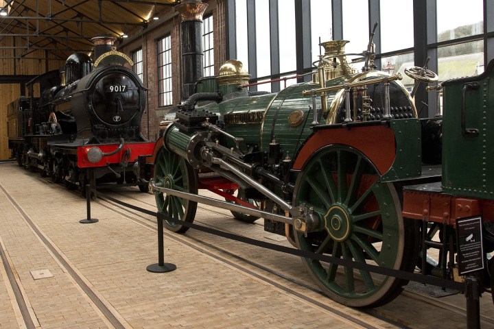 a train is parked on the side of a building