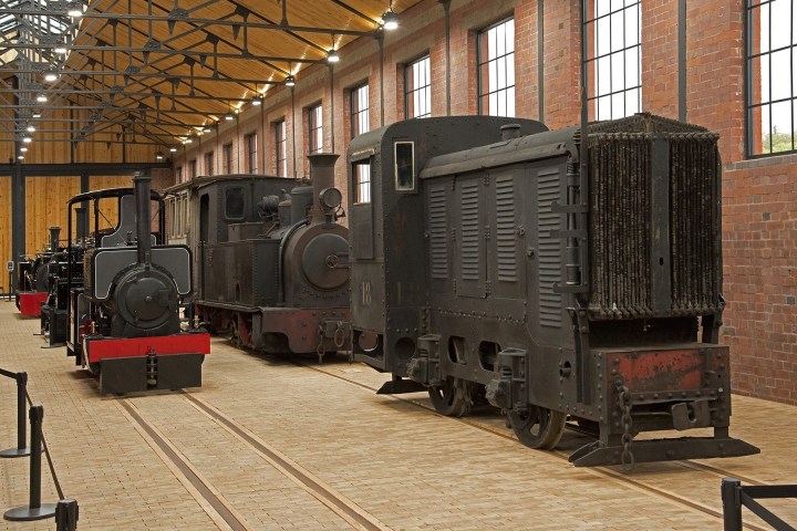 a train is parked on the side of a building