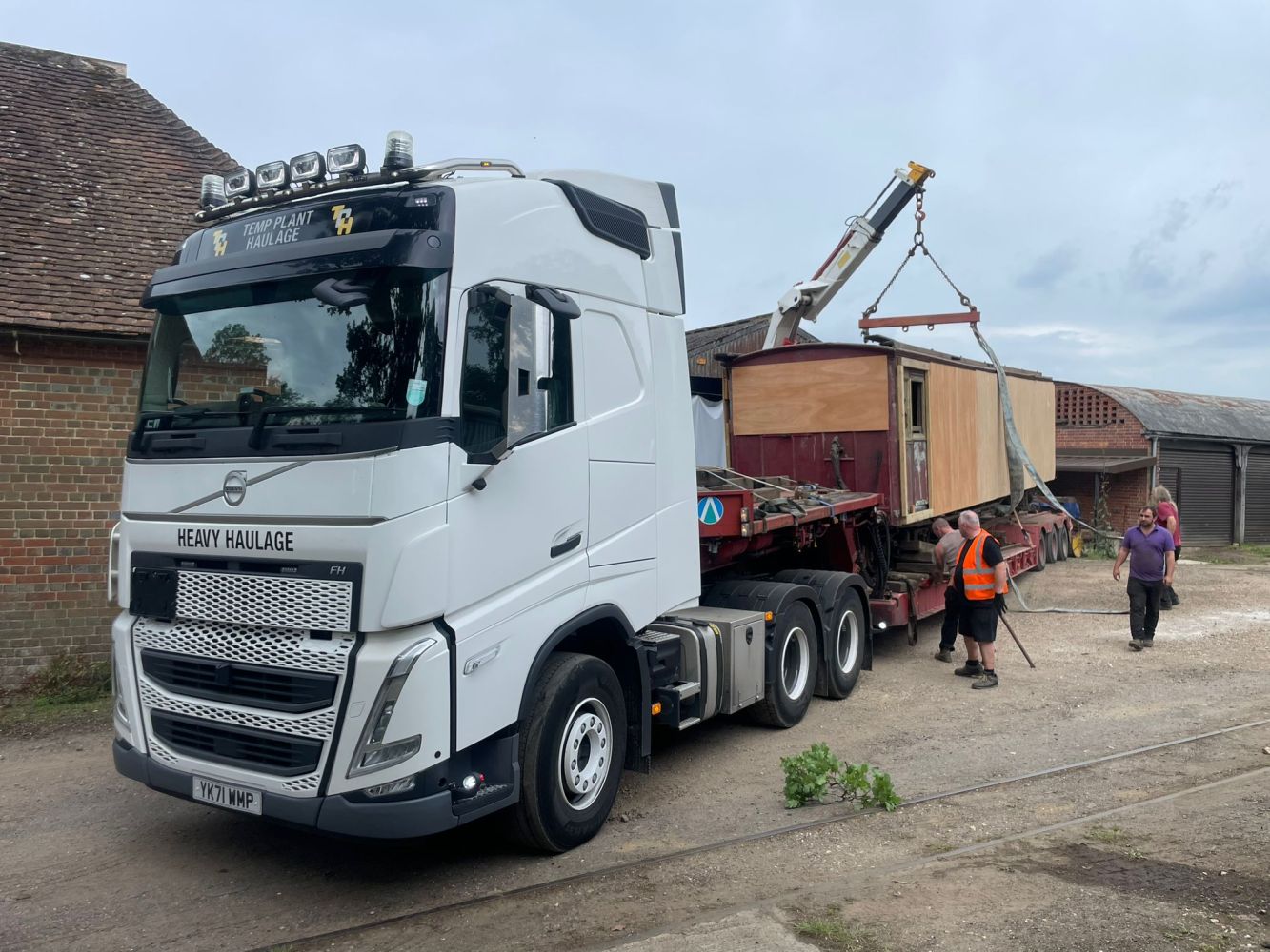 a truck driving down a dirt road