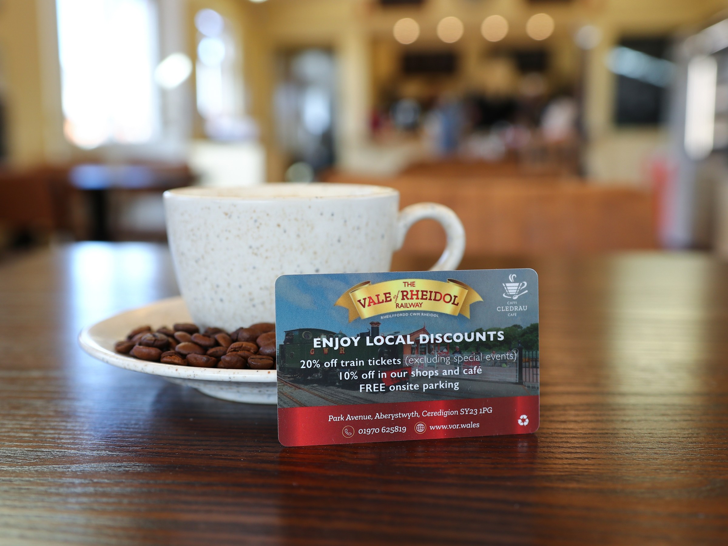 Coffee cup on table with discount card for Vale of Rheidol Railway.