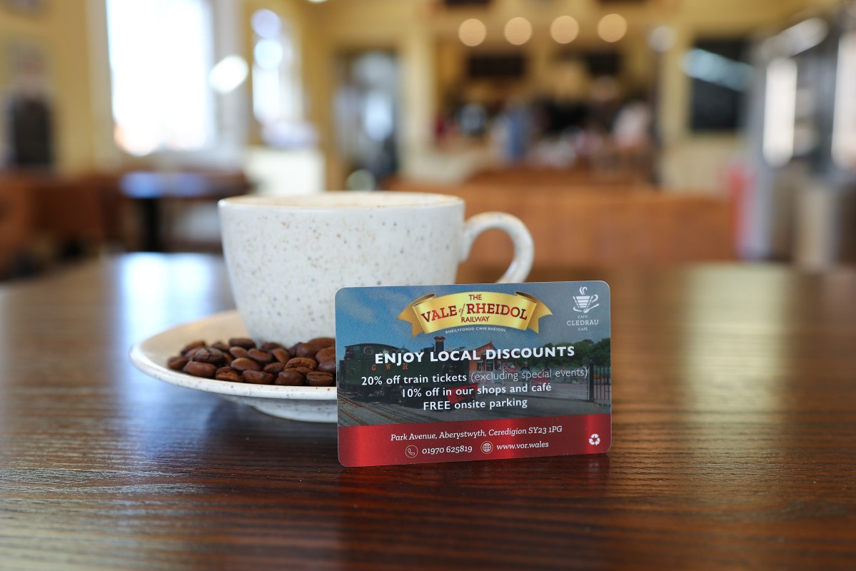 Coffee cup on table with discount card for Vale of Rheidol Railway.