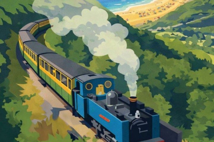 Steam train on coastal track with beach and ocean view.