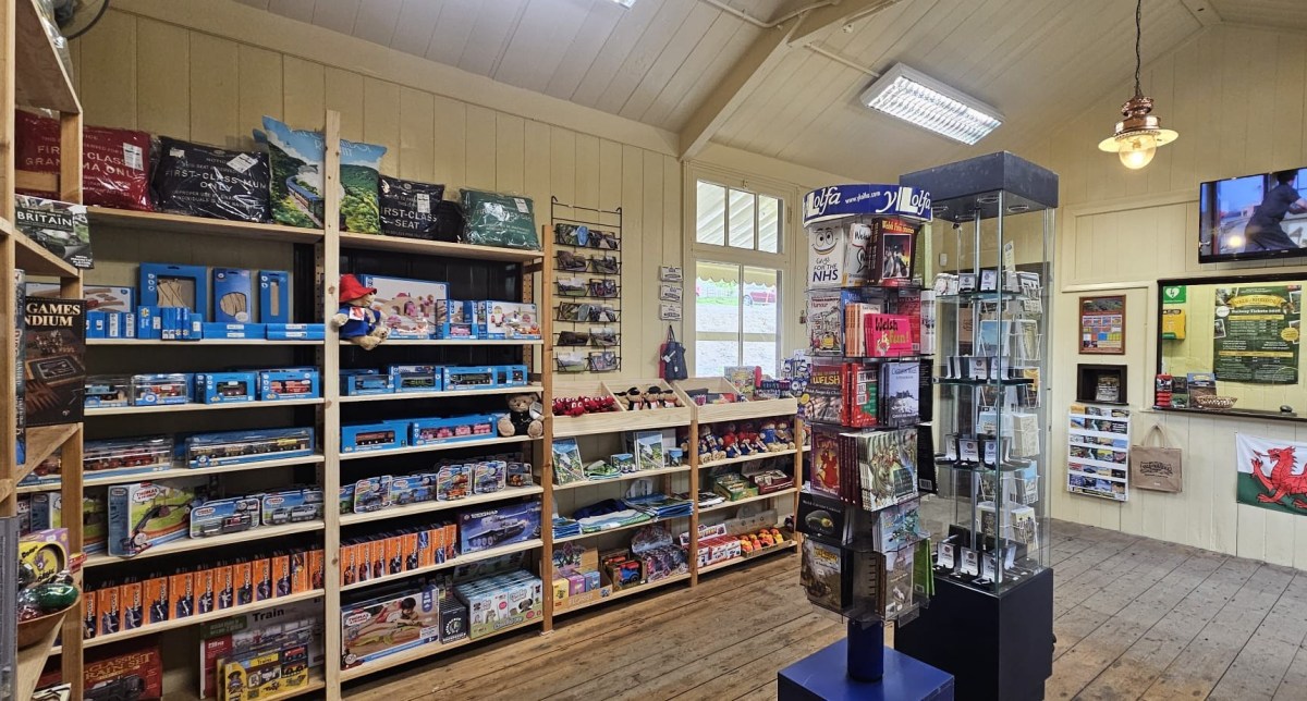 A small hobby shop with shelves of games, models, and collectibles.
