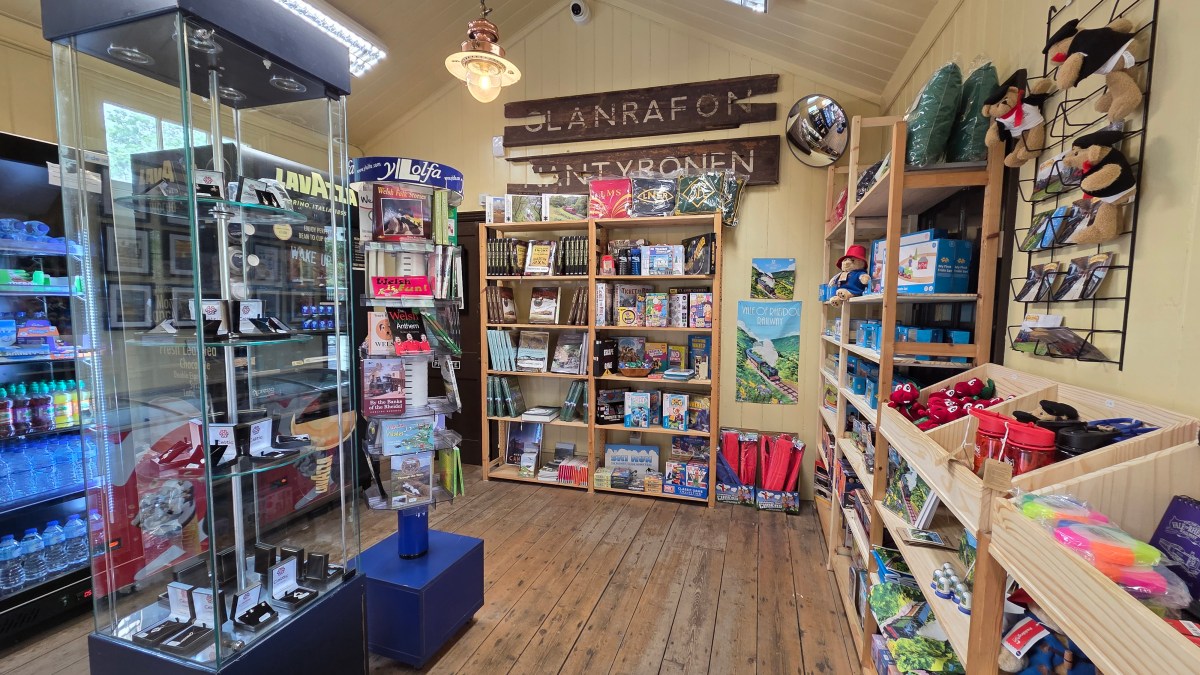 Gift shop interior with shelves of souvenirs, books, and local crafts.