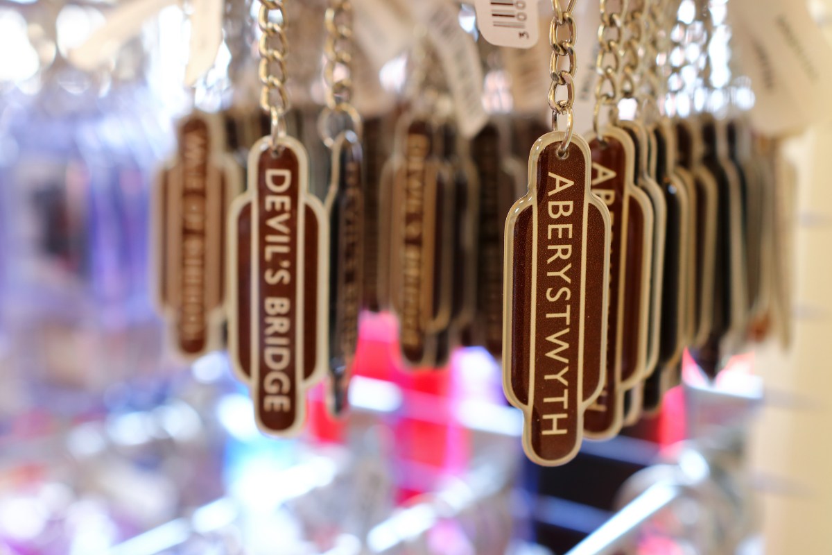 Keychains with labels 'Devil's Bridge' and 'Aberystwyth' hanging on a display.